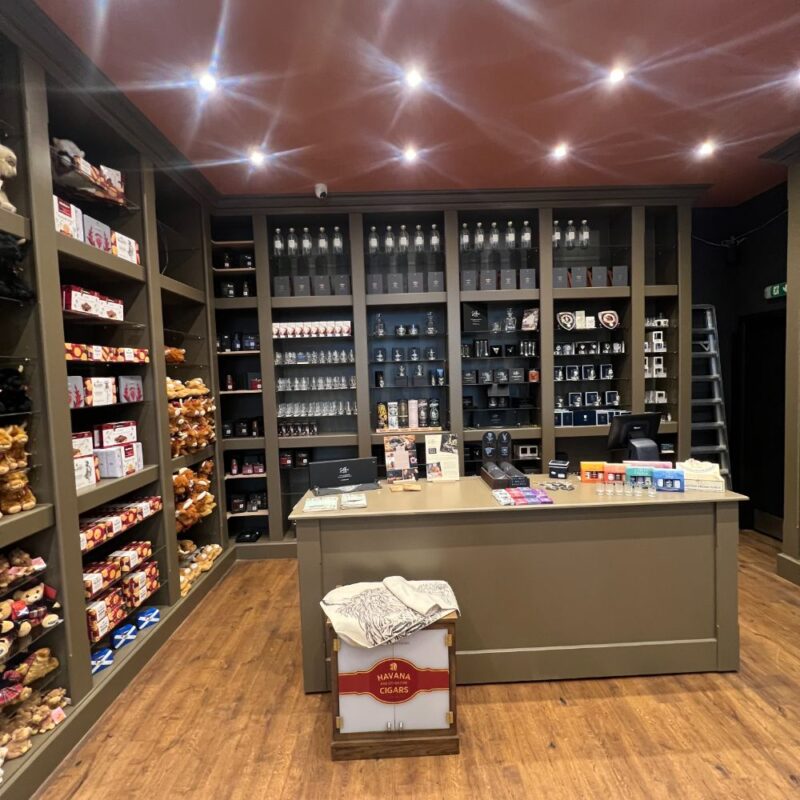 dark olive coloured shelfs displaying products for sale