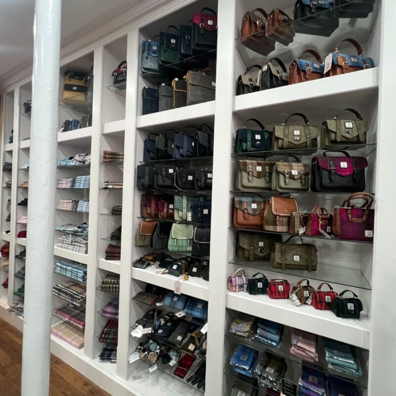 white shelfs displaying handbags